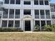 Three-story condo building featuring screened-in porches and well-maintained landscaping at 4802 51St W St # 1724, Bradenton, FL 34210