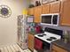 Functional kitchen equipped with a range, microwave, and a well-organized refrigerator at 4802 51St W St # 1724, Bradenton, FL 34210