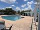 Community pool with brick patio, pergola and seating area, surrounded by well maintained landscaping at 4802 51St W St # 1724, Bradenton, FL 34210