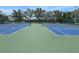 Outdoor tennis courts with blue and green playing surfaces, set against a backdrop of trees at 4802 51St W St # 1724, Bradenton, FL 34210