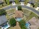 Aerial view of home featuring a screened pool, set within a neatly maintained neighborhood at 4951 Brightstone Pl, Spring Hill, FL 34609