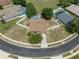 Aerial view of home with a screened pool, surrounded by a white fence and lush greenery at 4951 Brightstone Pl, Spring Hill, FL 34609