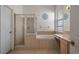 Bright bathroom features a separate glass enclosed shower and a built-in tub at 4951 Brightstone Pl, Spring Hill, FL 34609