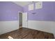 Bedroom features wood floors, white wainscotting, and a connecting door at 4951 Brightstone Pl, Spring Hill, FL 34609