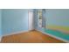 Bedroom features light blue walls, laminate flooring, and a window at 4951 Brightstone Pl, Spring Hill, FL 34609