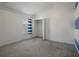 Neutral bedroom with a gray carpet, natural light from a window and a reach-in closet at 4951 Brightstone Pl, Spring Hill, FL 34609