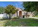 Charming single-story home with a well-manicured lawn, mature trees, and a welcoming entryway at 4951 Brightstone Pl, Spring Hill, FL 34609