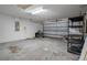 Spacious garage with a roll-up door and overhead lighting at 4951 Brightstone Pl, Spring Hill, FL 34609