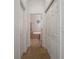 Hallway view leading to a bathroom featuring tile flooring, a tub, and a separate glass shower enclosure at 4951 Brightstone Pl, Spring Hill, FL 34609