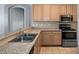 A kitchen featuring granite countertops, stainless steel appliances, and light wood cabinets at 4951 Brightstone Pl, Spring Hill, FL 34609