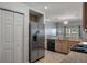 Kitchen area with stainless steel refrigerator and an open view to the rest of the home at 4951 Brightstone Pl, Spring Hill, FL 34609