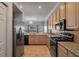 Bright kitchen with granite countertops, stainless steel appliances, tile backsplash, and a garden view at 4951 Brightstone Pl, Spring Hill, FL 34609