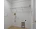 Empty laundry room area with tile floors, white walls and in-wall hookups at 4951 Brightstone Pl, Spring Hill, FL 34609