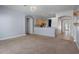 Bright open floor plan featuring carpet flooring, seamlessly connecting to the kitchen at 4951 Brightstone Pl, Spring Hill, FL 34609