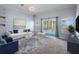 Bright living room is staged with sofa and ottoman set, overlooking the pool at 4951 Brightstone Pl, Spring Hill, FL 34609
