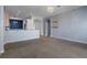 Open-concept living area showcases neutral carpet flooring and elegant chandelier at 4951 Brightstone Pl, Spring Hill, FL 34609
