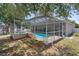 The home has a screen-enclosed pool and hot tub, with outdoor furniture nearby at 4951 Brightstone Pl, Spring Hill, FL 34609