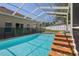 Spacious screened-in pool with a spa and outdoor seating at 4951 Brightstone Pl, Spring Hill, FL 34609