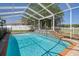 Gorgeous screened-in pool features a waterfall and spa area at 4951 Brightstone Pl, Spring Hill, FL 34609