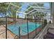 Beautiful screened-in pool includes waterfall feature and spa at 4951 Brightstone Pl, Spring Hill, FL 34609