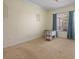Bright, empty room showcasing neutral walls, and a window with light blue curtains at 4951 Brightstone Pl, Spring Hill, FL 34609