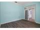 Inviting room featuring wood-look flooring, blue walls, and natural light at 4951 Brightstone Pl, Spring Hill, FL 34609