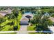 Beautiful single-Gathering home with a well-manicured lawn and an attached garage overlooking a serene lake at 5020 Torrey Pines Run, Bradenton, FL 34211