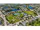 Aerial view of a community showcasing lakes, lush green spaces, playgrounds, and tennis courts for active living at 5020 Torrey Pines Run, Bradenton, FL 34211