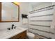 A bathroom with a shower, sink, and a decorative black and white curtain at 5020 Torrey Pines Run, Bradenton, FL 34211