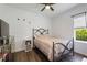 This bedroom features a ceiling fan, a side table, and a window at 5020 Torrey Pines Run, Bradenton, FL 34211