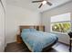 This bedroom features a ceiling fan, a desk, and a window with views of palm trees at 5020 Torrey Pines Run, Bradenton, FL 34211