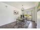 Inviting dining area with a farmhouse-style table, modern chandelier, and natural light at 5020 Torrey Pines Run, Bradenton, FL 34211
