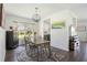 Charming dining room features a rustic wood table, designer rug, and contemporary lighting at 5020 Torrey Pines Run, Bradenton, FL 34211