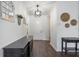 Bright foyer featuring dark wood floors, neutral walls, and decorative accents at 5020 Torrey Pines Run, Bradenton, FL 34211