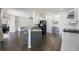 Open concept kitchen featuring stainless steel appliances, gray countertops, and bar seating at 5020 Torrey Pines Run, Bradenton, FL 34211