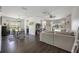 Bright open concept living and dining area boasts dark wood floors and a view of the pool and lake at 5020 Torrey Pines Run, Bradenton, FL 34211