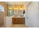 The main bath includes double sinks, modern lighting, and a glass-enclosed walk-in shower at 5020 Torrey Pines Run, Bradenton, FL 34211