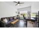 Comfortable home office with a ceiling fan, large window, couch and desk space at 5020 Torrey Pines Run, Bradenton, FL 34211