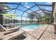 Stunning screened-in pool area with sun loungers, outdoor dining, and picturesque lake views at 5020 Torrey Pines Run, Bradenton, FL 34211