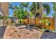 Brick patio with lush landscaping, privacy fence and mature palm trees in backyard at 513 25Th W Ave, Bradenton, FL 34205