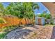 Landscaped backyard with brick patio, privacy fence, storage shed, and shade trees at 513 25Th W Ave, Bradenton, FL 34205