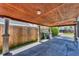Covered parking area with wood ceiling, concrete floor, and direct access to the house at 513 25Th W Ave, Bradenton, FL 34205