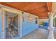 Home entryway featuring wood-look flooring, painted blue exterior, and an open view to other rooms at 513 25Th W Ave, Bradenton, FL 34205