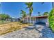 Charming home featuring a light blue exterior, covered parking, and a neatly bricked driveway at 513 25Th W Ave, Bradenton, FL 34205