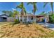 Charming light blue single story home with front porch and well-manicured front yard at 513 25Th W Ave, Bradenton, FL 34205