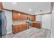 Renovated kitchen with stainless steel appliances, stone countertops, and wood-look vinyl flooring at 513 25Th W Ave, Bradenton, FL 34205
