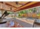 Spacious covered patio features wood ceiling, tile flooring, and backyard views at 513 25Th W Ave, Bradenton, FL 34205