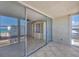 Balcony with sliding glass doors and tile flooring, offering stunning ocean and city views at 5300 Gulf Dr # 501, Holmes Beach, FL 34217