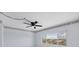Bedroom featuring a ceiling fan, light walls, and a window with a view of the outside at 5300 Gulf Dr # 501, Holmes Beach, FL 34217
