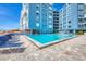 Outdoor pool with deck chairs and complex in background, perfect for relaxation at 5300 Gulf Dr # 501, Holmes Beach, FL 34217